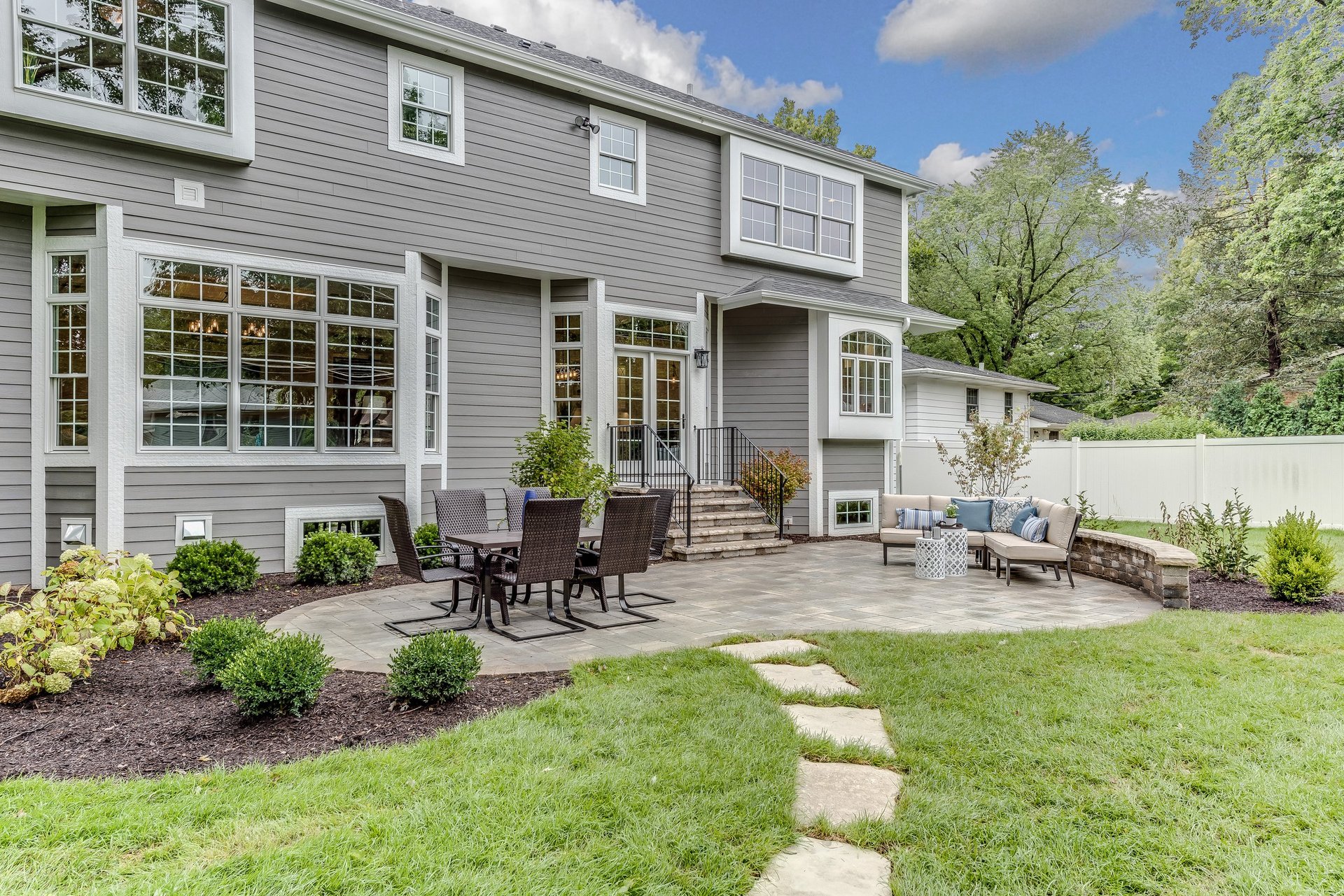 Dream home outdoor entertaining space with patio and landscaping