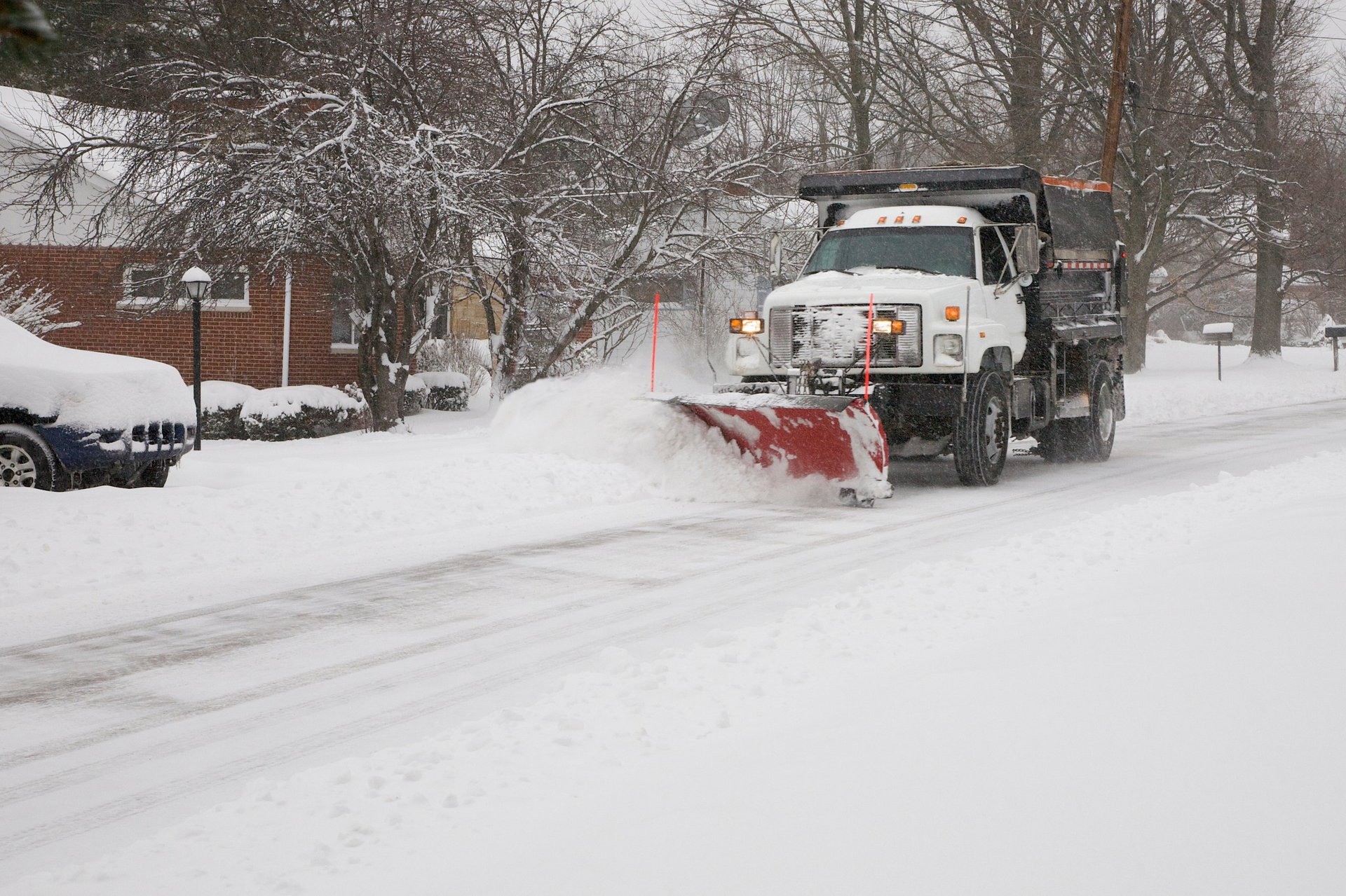 Snow plow removing snow from street