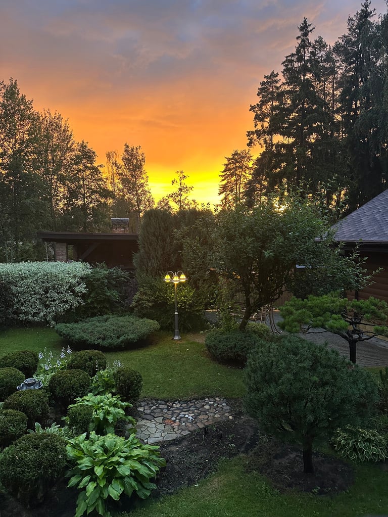 Summer garden with sunset country landscape